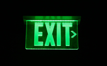Neon Green Exit Sign set on black [image source]