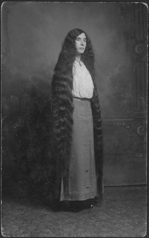 Portrait of a young woman with long hair almost to the floor, circa 1900s. (Photo by: PYMCA/UIG via Getty Images)