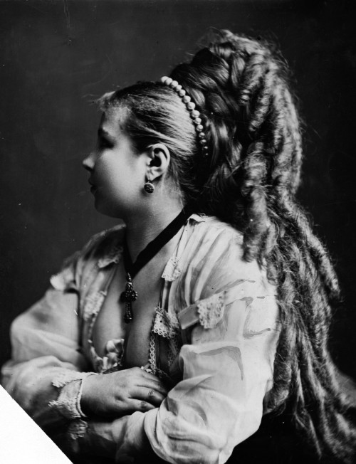 circa 1870:  A woman with a locks of hair carefully curled and falling down her back.  (Photo by Hulton Archive/Getty Images)